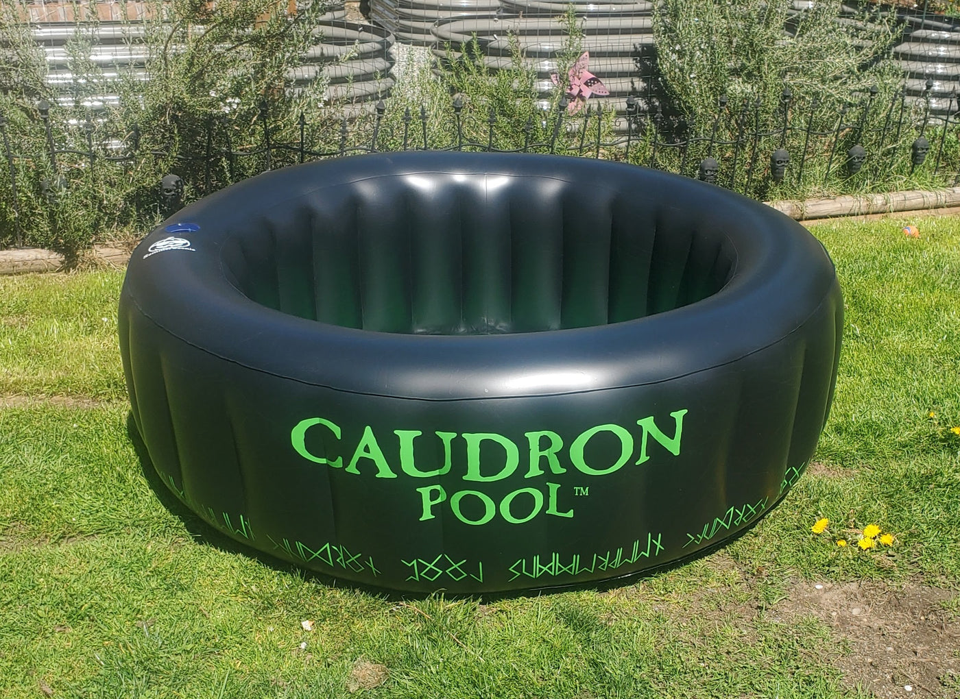 Black inflatable cauldron pool with green interior