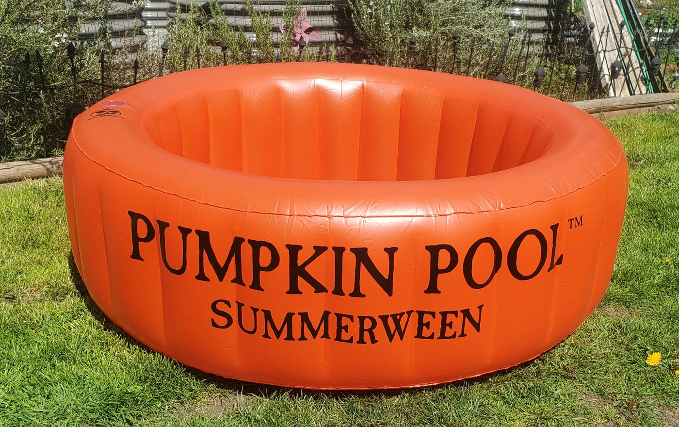 Orange inflatable pumpkin pool in a backyard